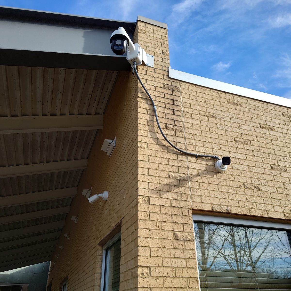 Security cameras installed at a commercial roofline