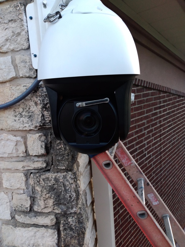 Real exterior security camera installation on a brick building